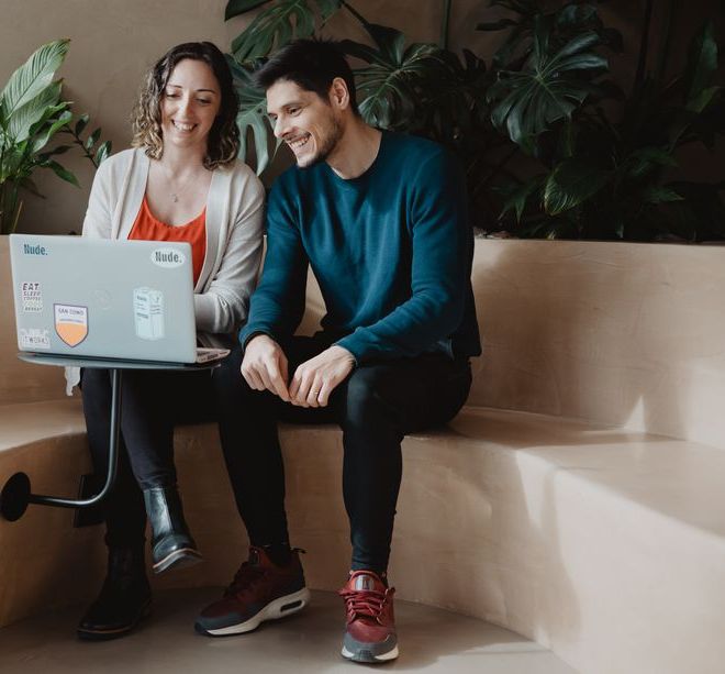 Coworkers sitted at the office sharing ideas on the computer