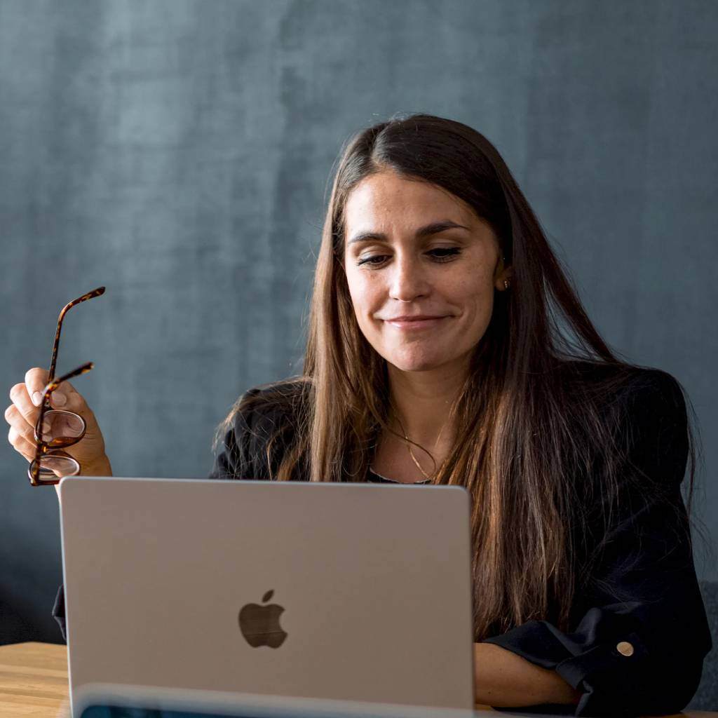 Business professional working on a laptop in a modern office.