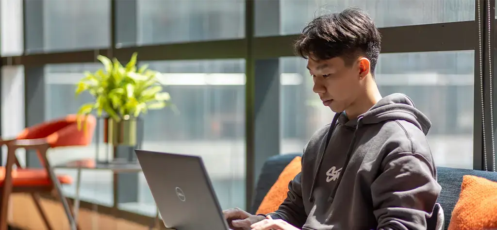 developer working on laptop in lounge area of the office