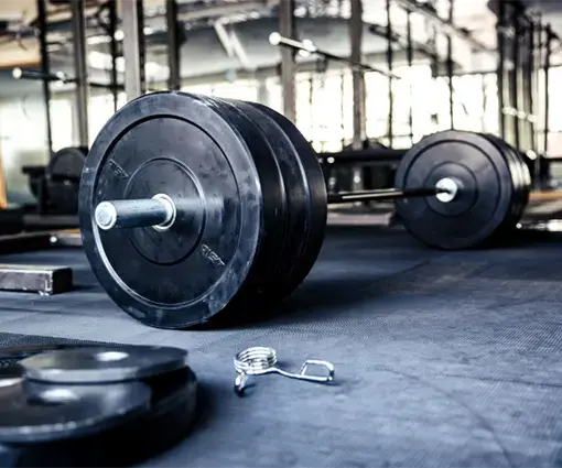 dead weights athletic gear on floor of gym