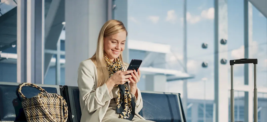 Woman with mobile phone in an airport