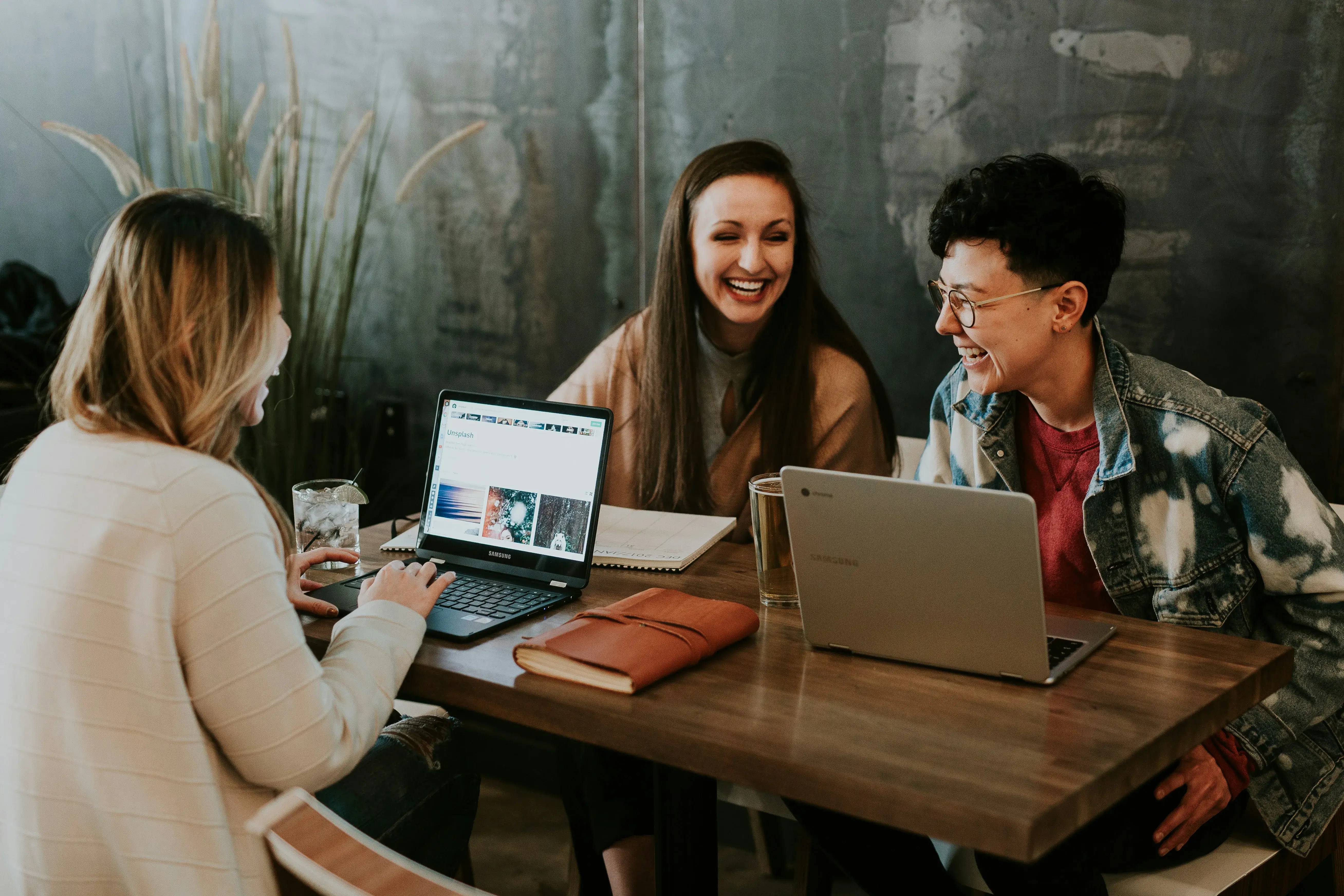 Three people sharing ideas and smiling