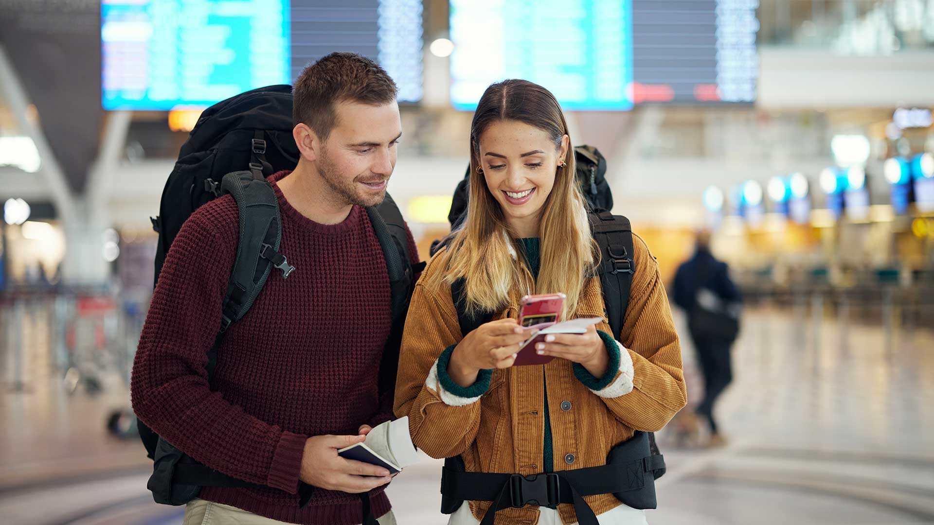 guy-and-girl-in-the-airport-watching-a-phone