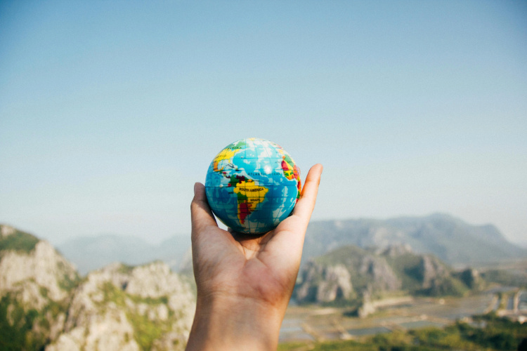 A hand with an Earth Globe