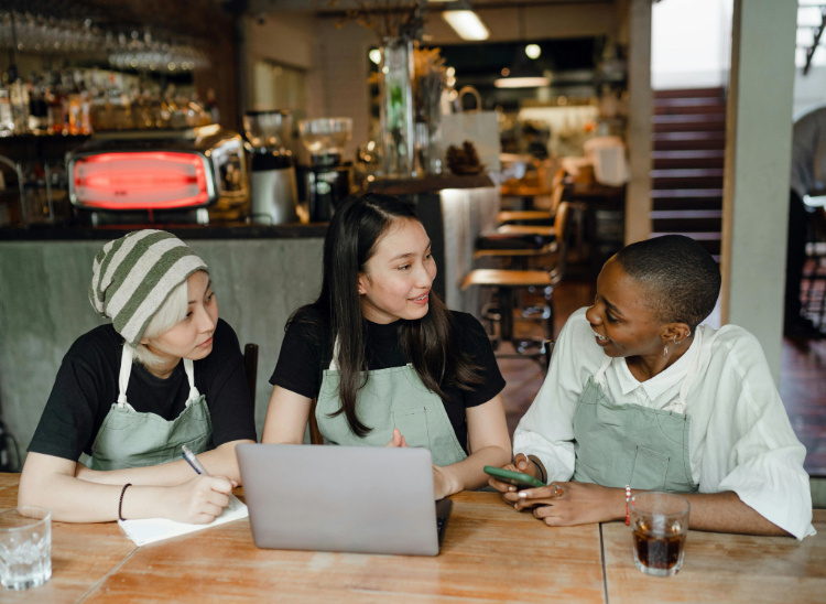 Three colleagues working in a coffee shop