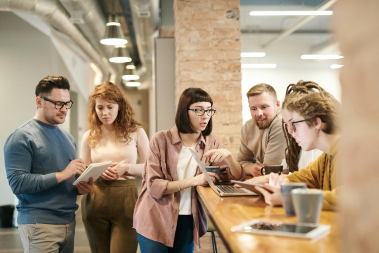 A group of colleagues talking at the office