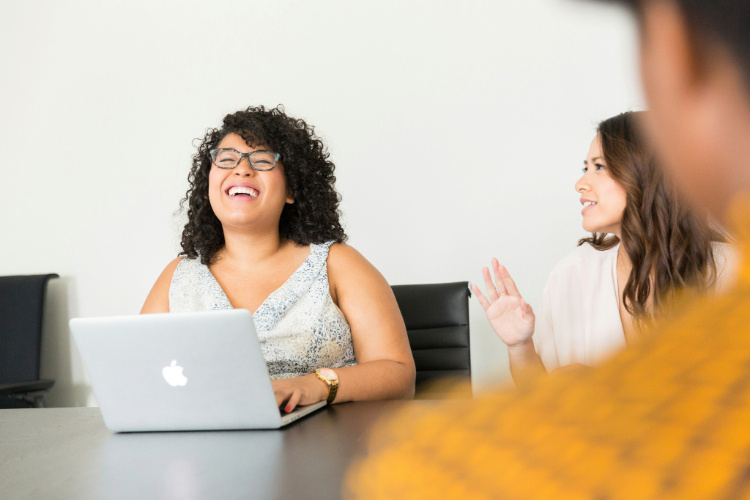 Three colleagues having a laugh in a meeting