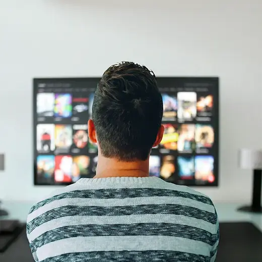 Man watching a streaming service on his television