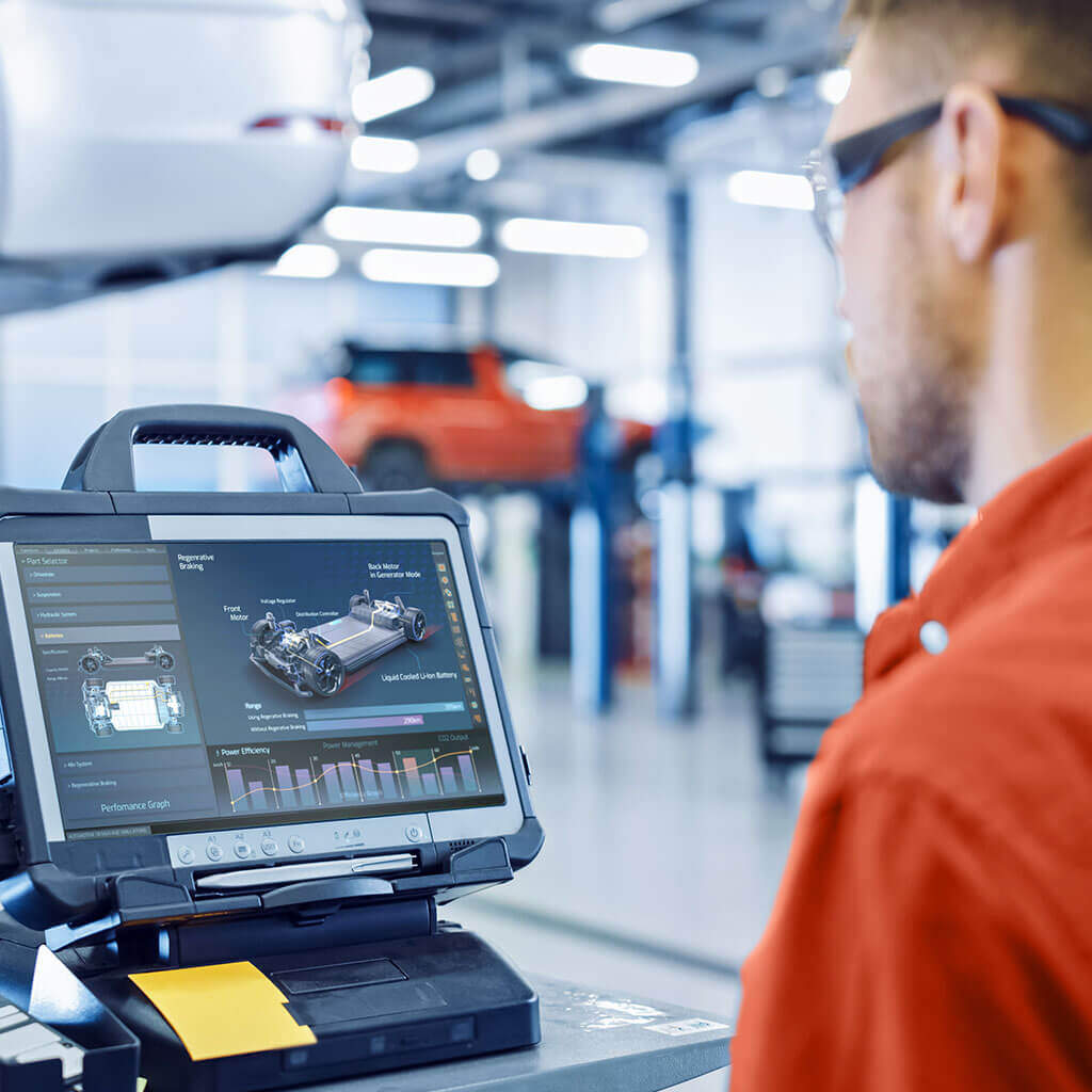 Automotive mechanic working with car computer