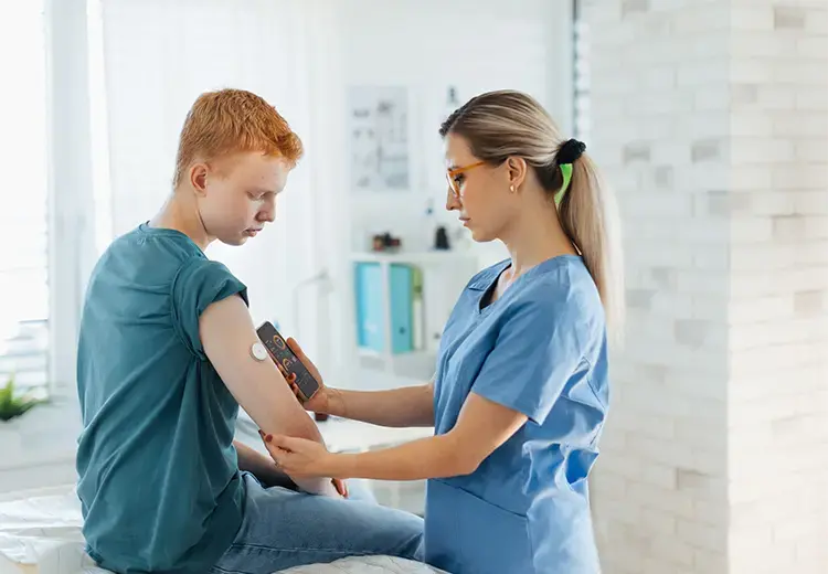 doctor using insulin device on young man 