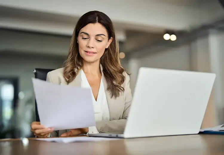 business-woman-reviewing-data-on-laptop-card