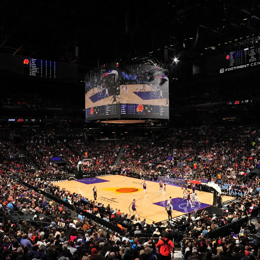 suns team playing on basketball court in full stadium