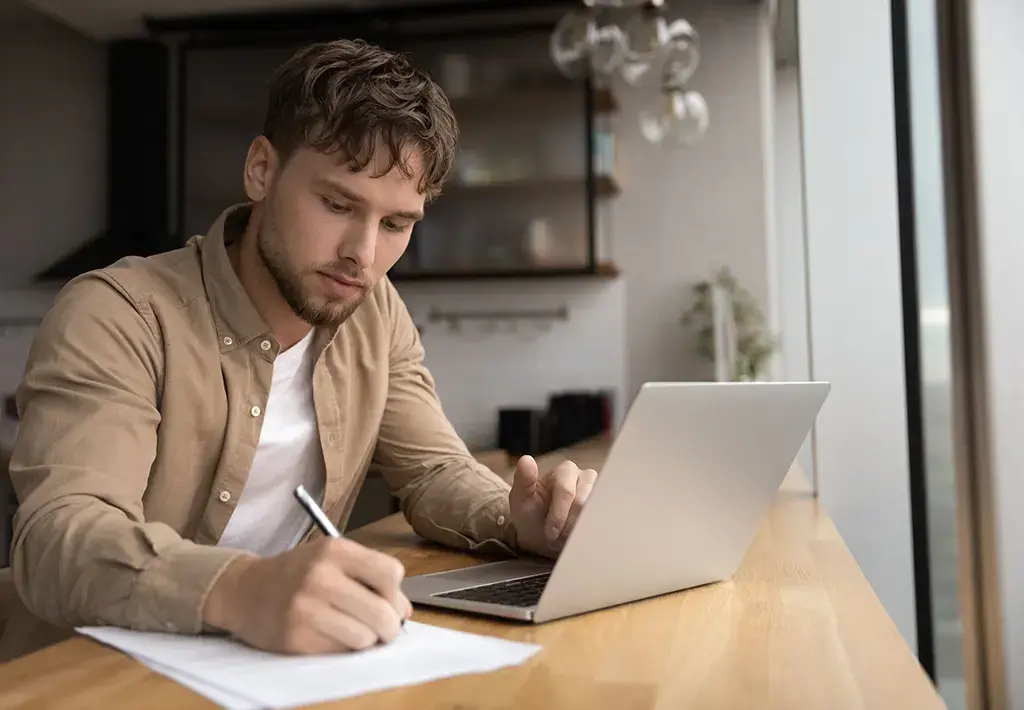 young man studying on his laptop