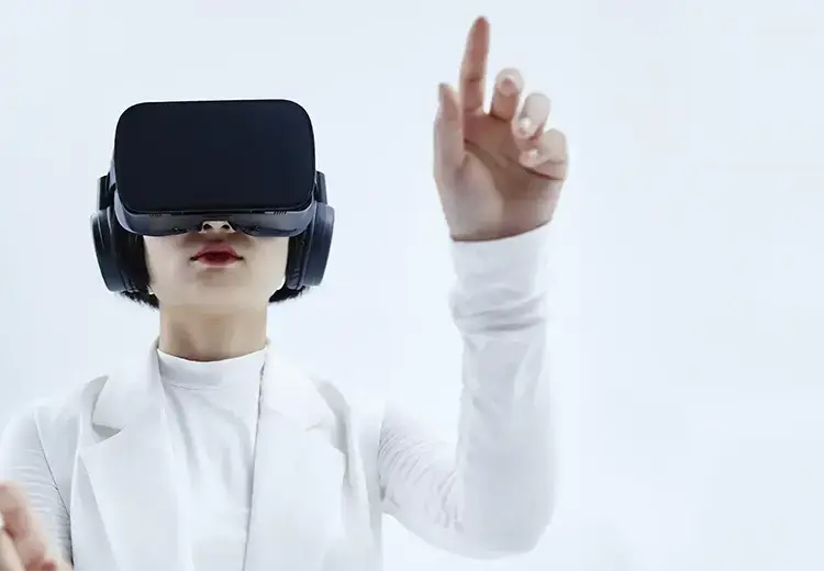 asian woman in all white wearing vr headset and pointing