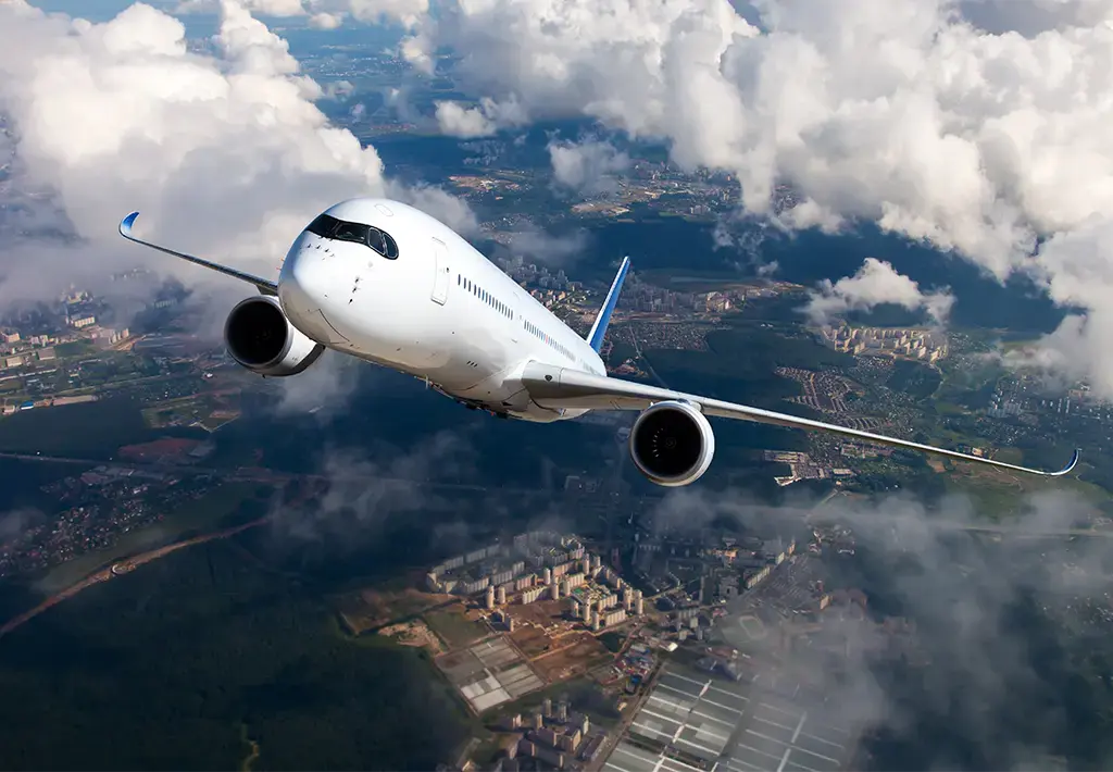 view looking down of airplane flying up through the clouds