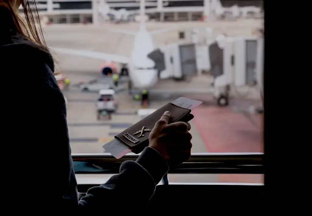 woman in airport holding her passport