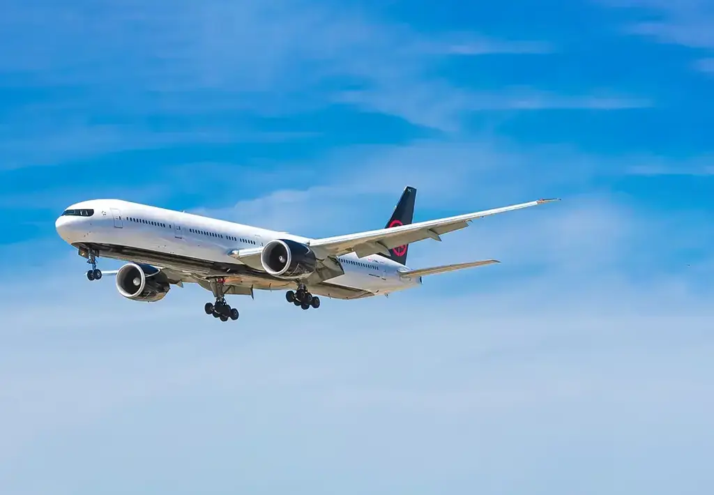 airplane flying in bright blue sky