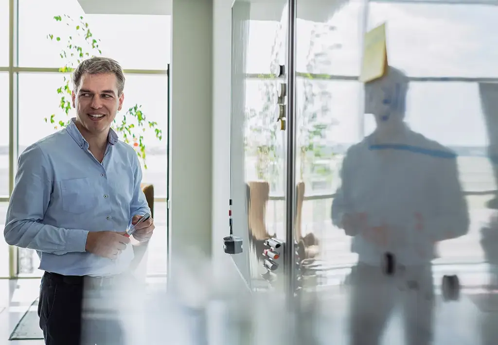 leader standing at whiteboard in office space