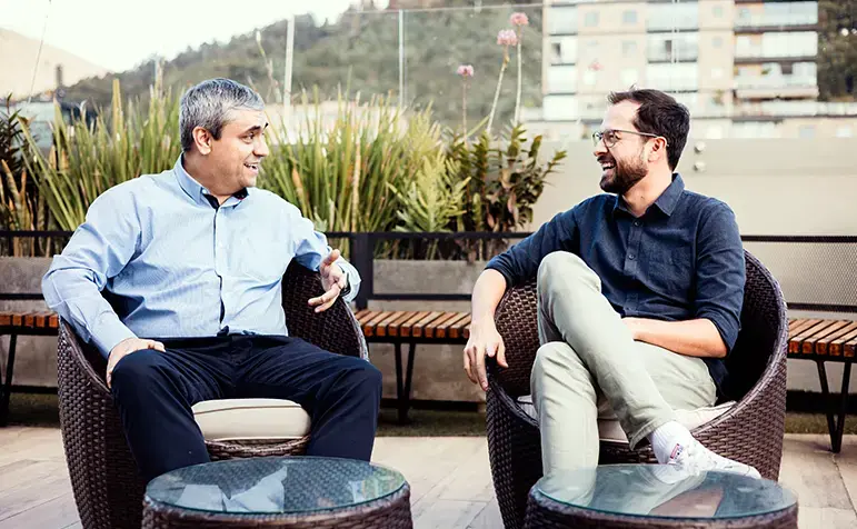 two endava employees talking insurance on company roof top deck