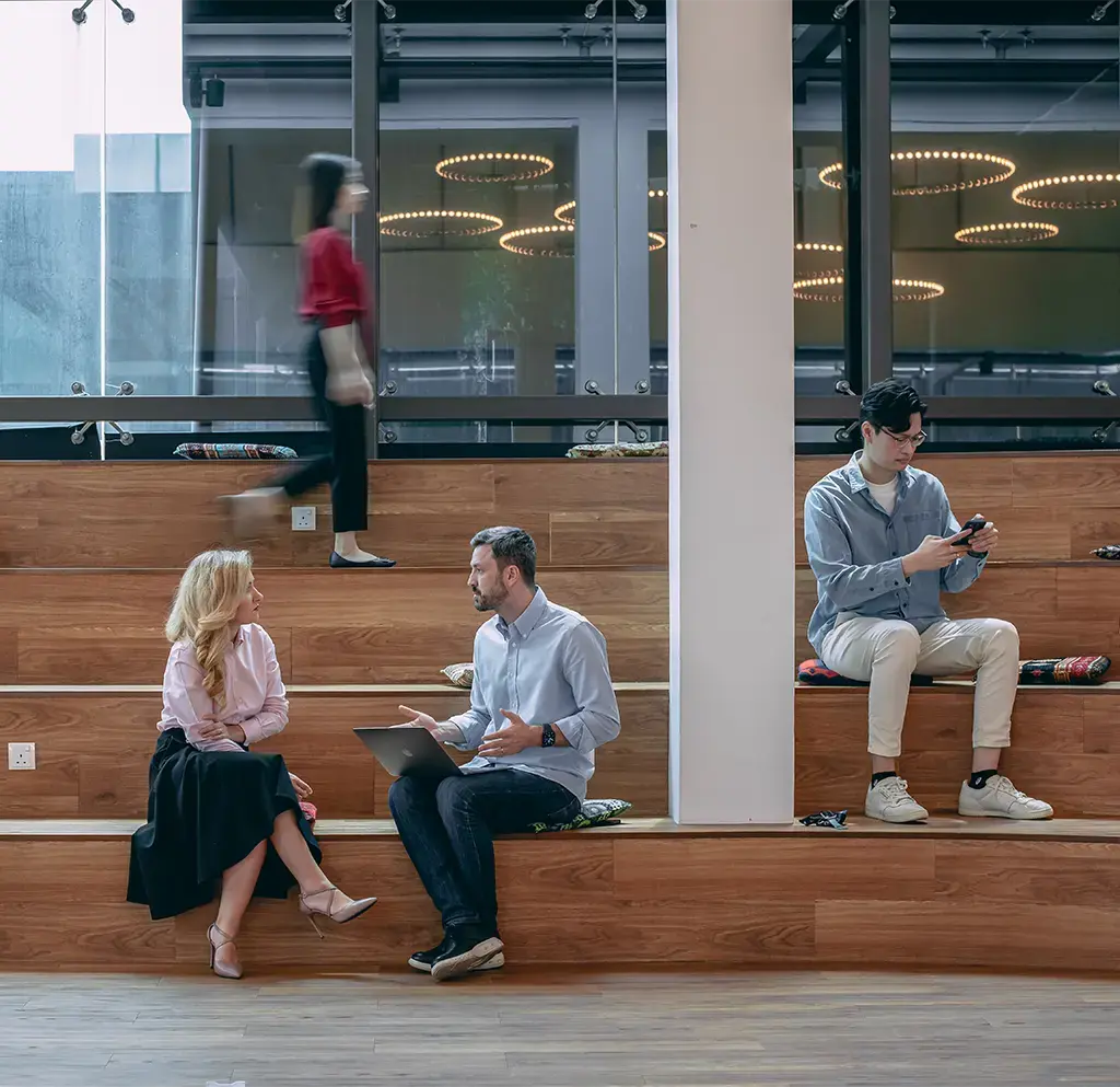 endava coworkers sitting on wood seating