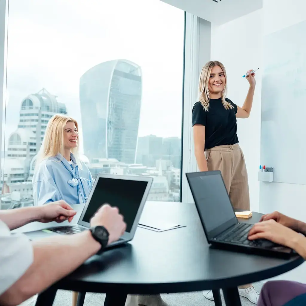 woman presenting on whiteboard at Endava London headquarters