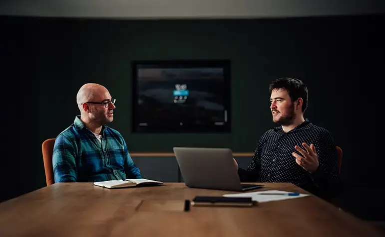 two men discussing tech reimagined in Endava London conference room