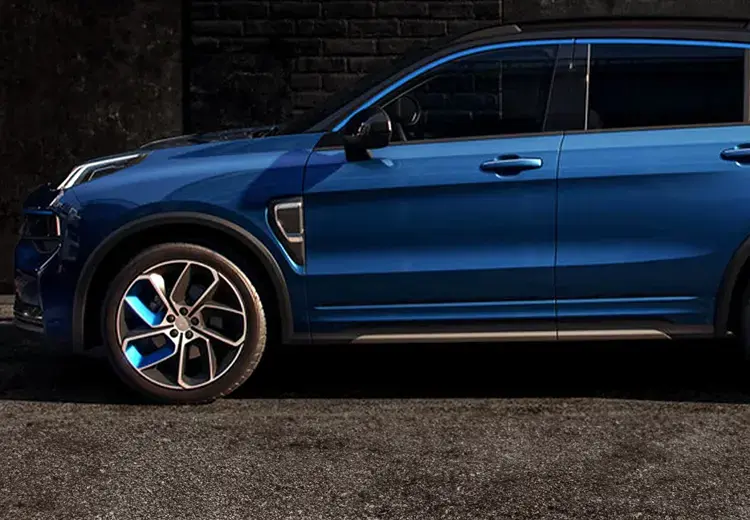 blue electric car parked on dark pavement