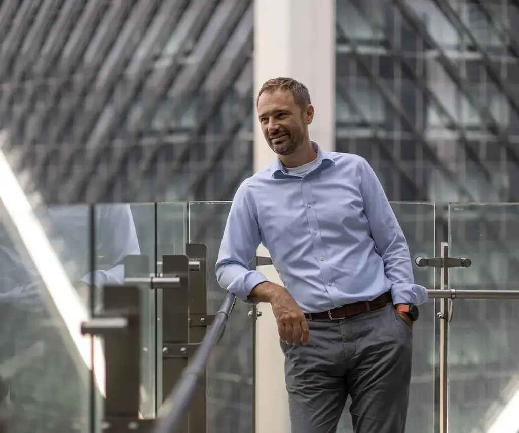 business man standing on office building balcony