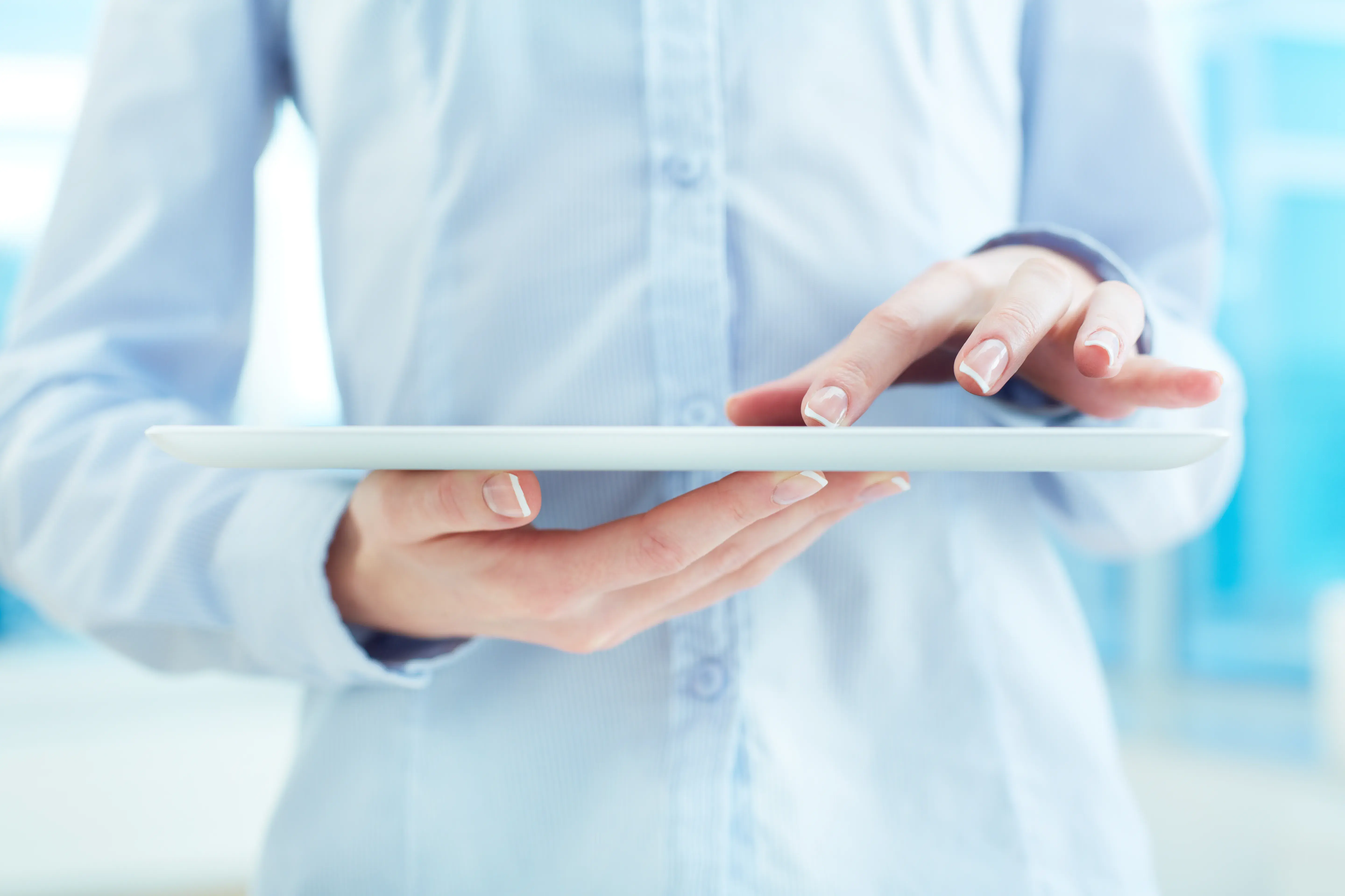 Woman holding tablet computer, focusing on Accelerating Health IT Compliance Safely.