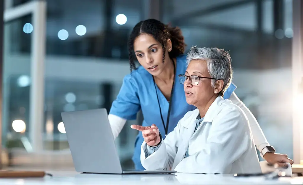 doctors consulting together on laptop