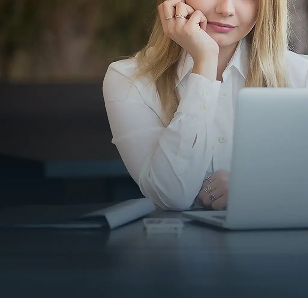 person gazing at their laptop