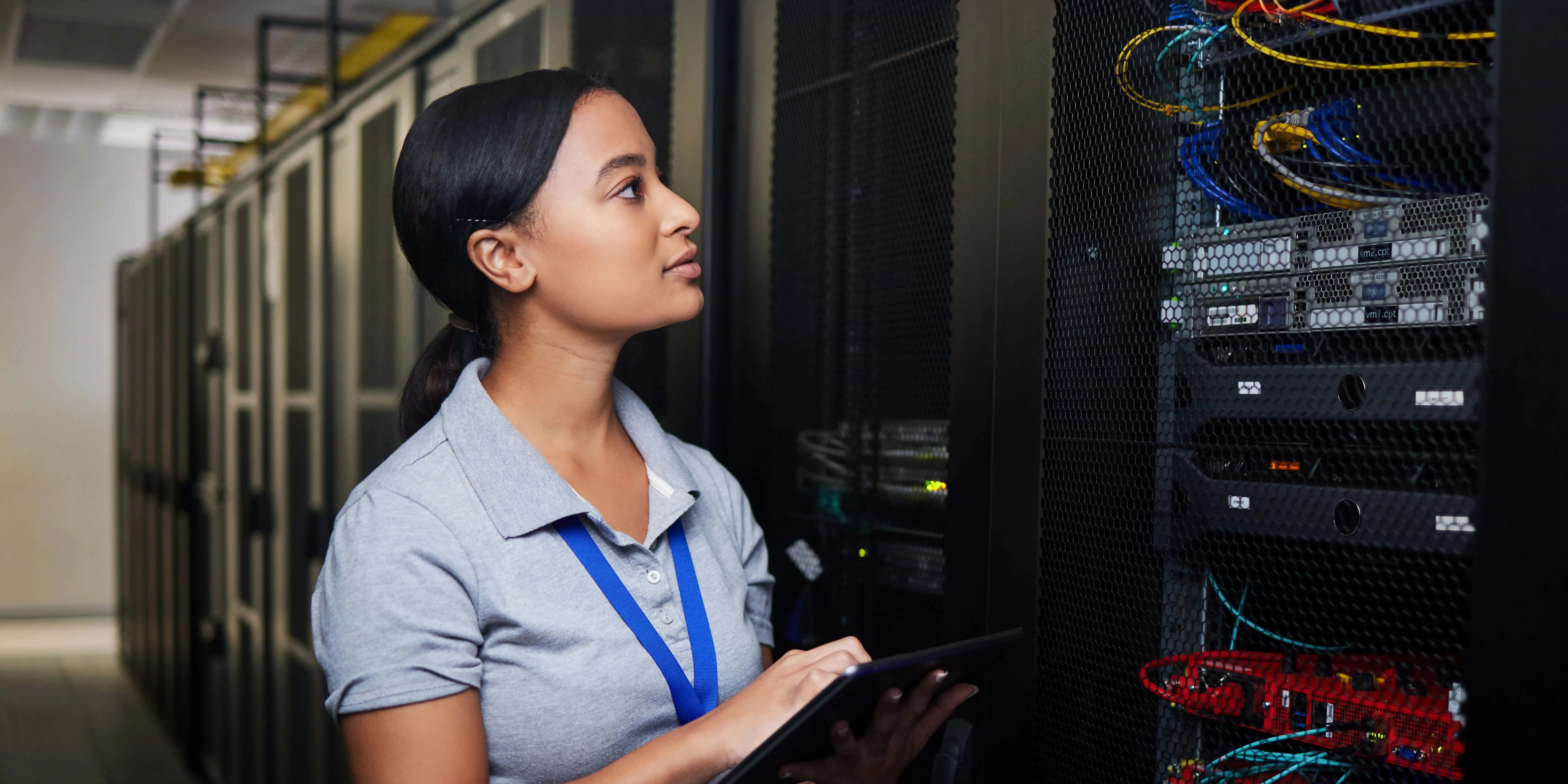 Woman engineer on a tablet in a server room