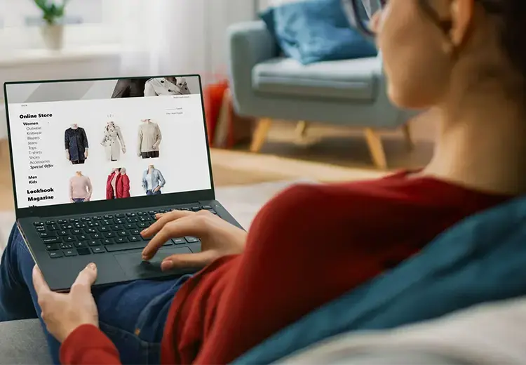 woman shopping online through her laptop in a living room