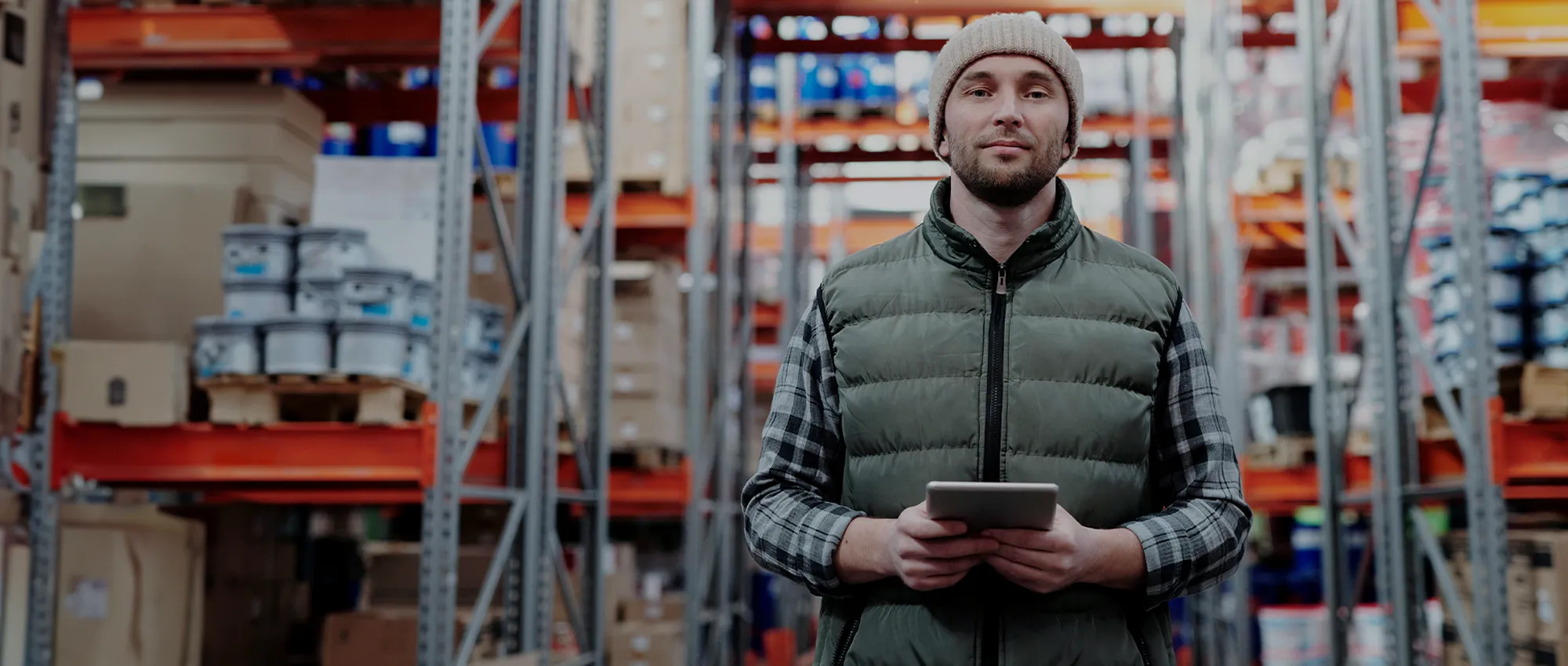 A man inside a supply chain and logistics warehouse.