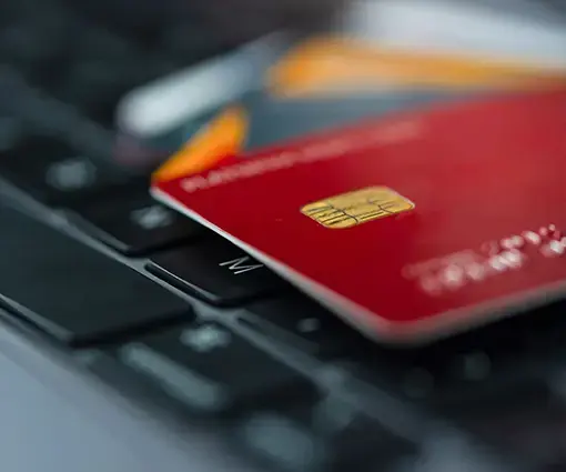 closeup of red credit card laying on credit card