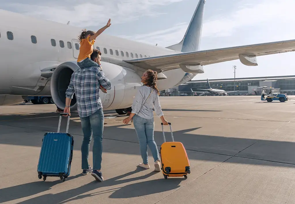 family standing near large with their luggage