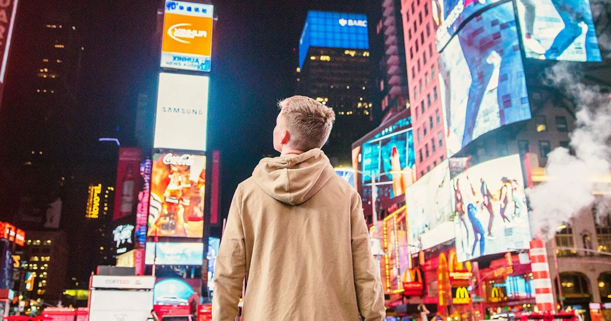 Male in the middle of a city at night