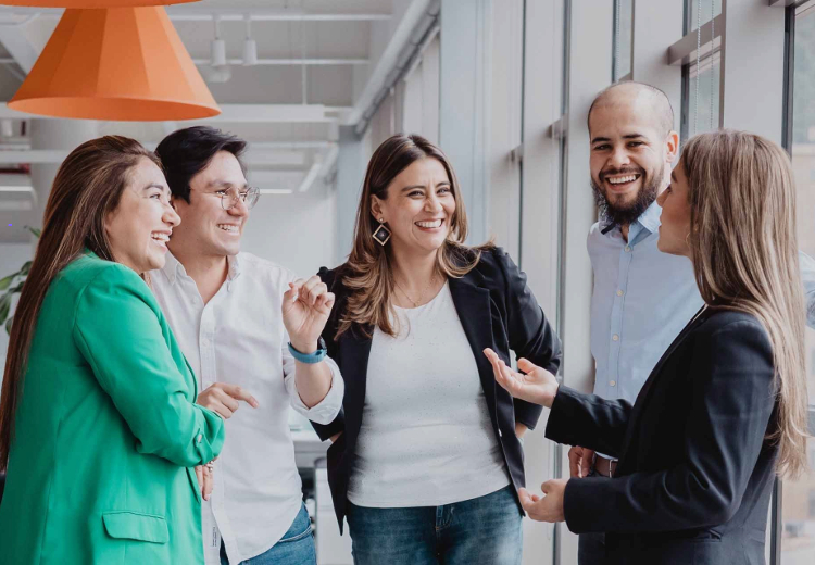 A group of people talking at the office