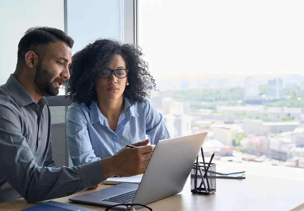 two-coworkers-looking-at-laptop-carousel-insight-expanded-2