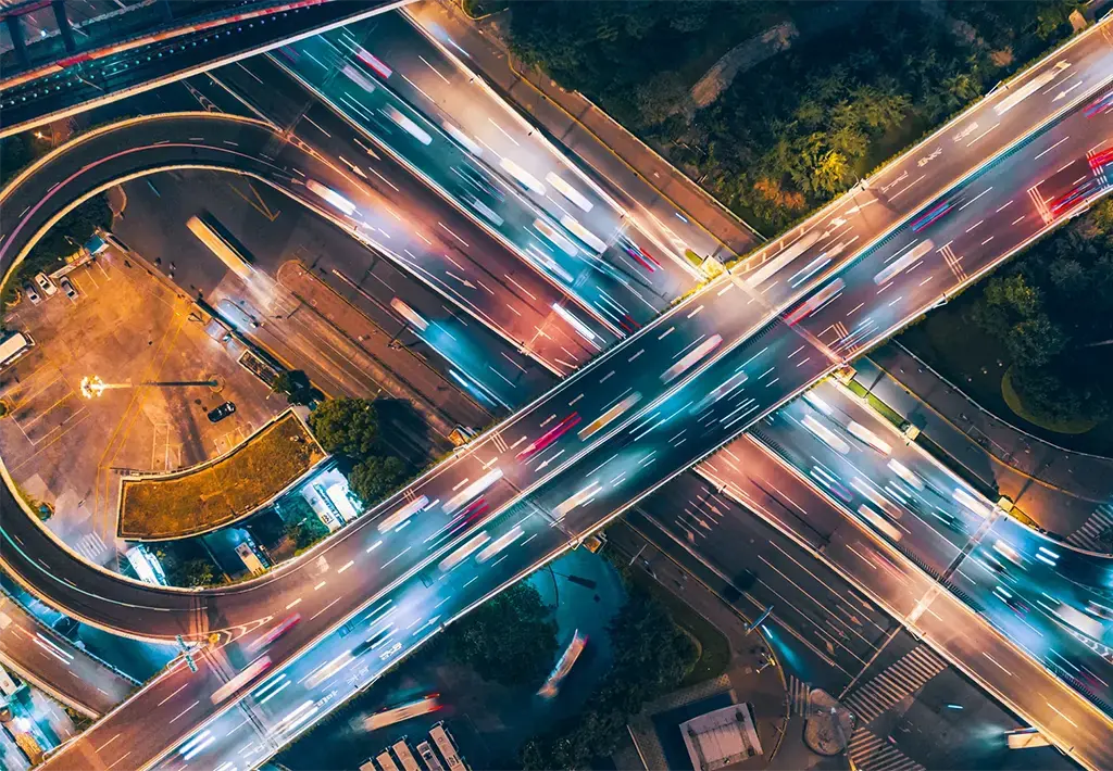 automotive lights on freeway cloverleaf interchange at night