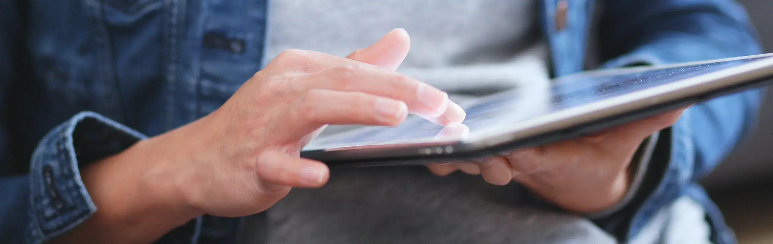 Man scrolling through videos on his tablet