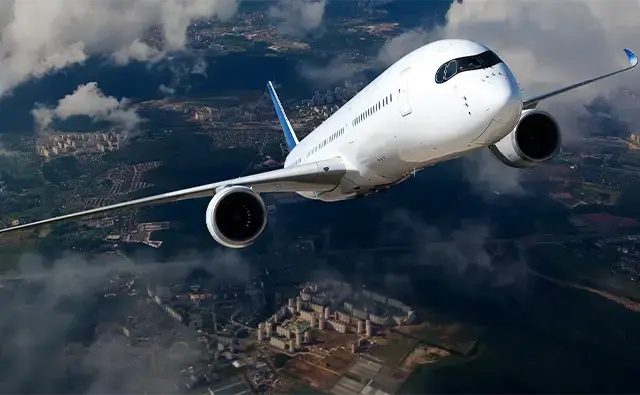 looking down at airplane flying towards camera in the sky